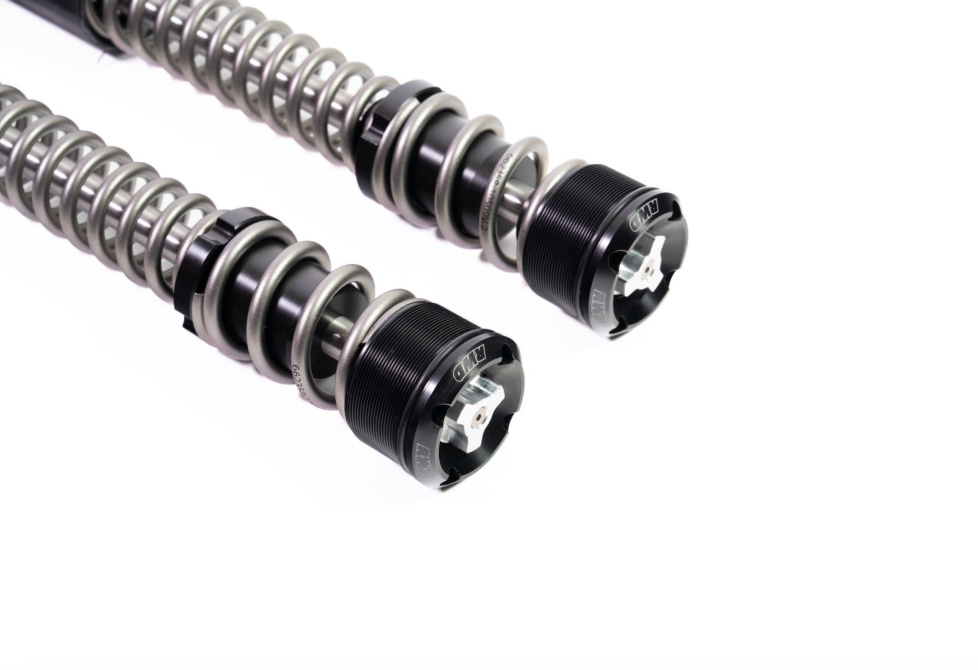 Two RWD V-Twin motorcycle fork springs with black caps and silver adjustment knobs, set against a white background.